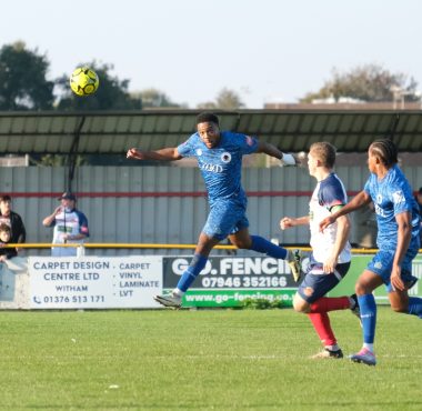 johnville renne wins a header against witham town